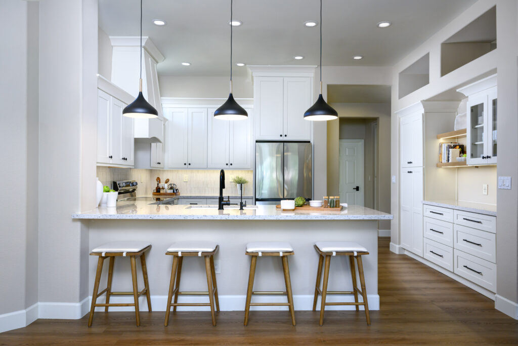 Neutral condominium living room in Winnetka featuring clean lines, crystal lighting, and floor-to-ceiling shades.